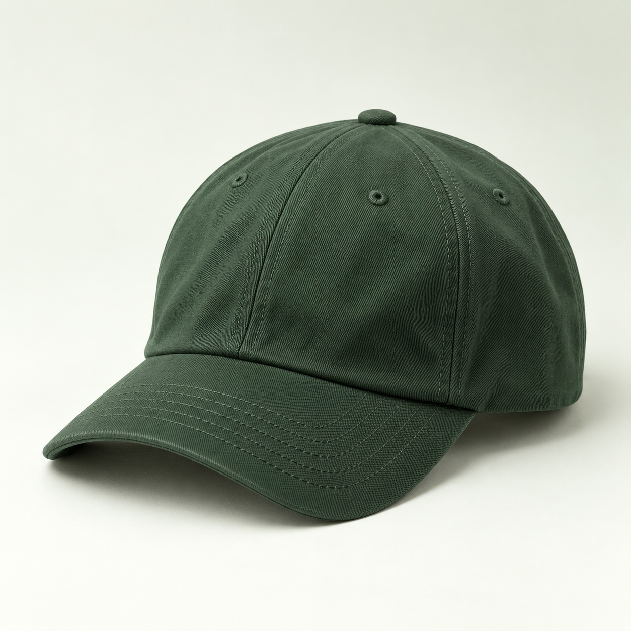 Dark sage cricket cap on a pale studio background