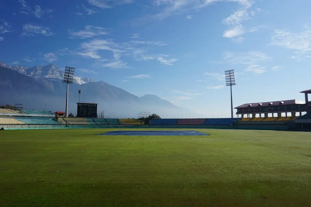 Cricket outfield with mountains beyond the boundary