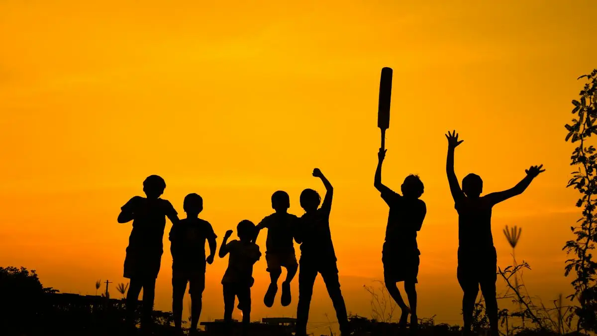 Players lifting cricket bats together in silhouette at sunset