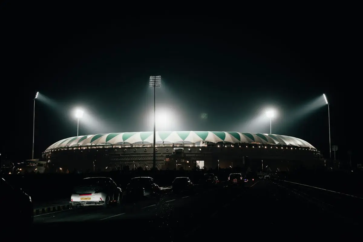 Cricket ground under floodlights at night